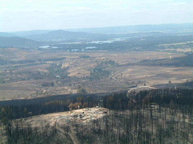 View of The Oddie and SLR facility on Stromlo with Lake Burley Griffin and Canberra's city centre in the background