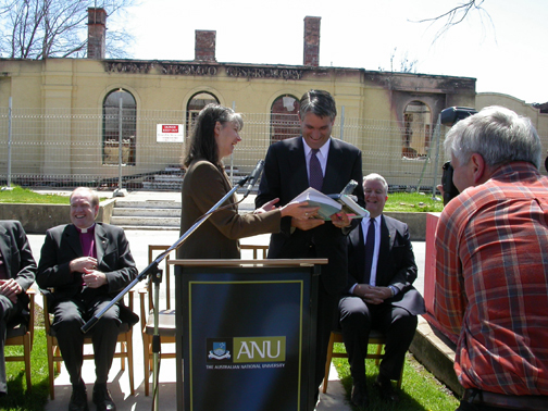 Penny Sackett presents a copy of the book, signed by the authors, to John Anderson.