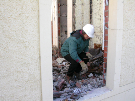 Denise Bourne, digging through the ruins of her office.