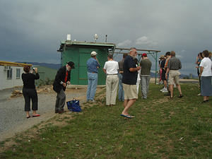 Members gathering for the official opening; so are the storm clouds