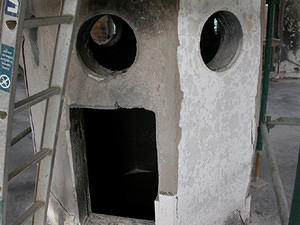 Although the cement render is flaking off and all wooden doors and hatches are burned, the tower is structurally sound.