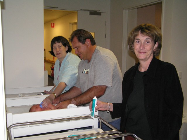 Three people bathing one baby!
