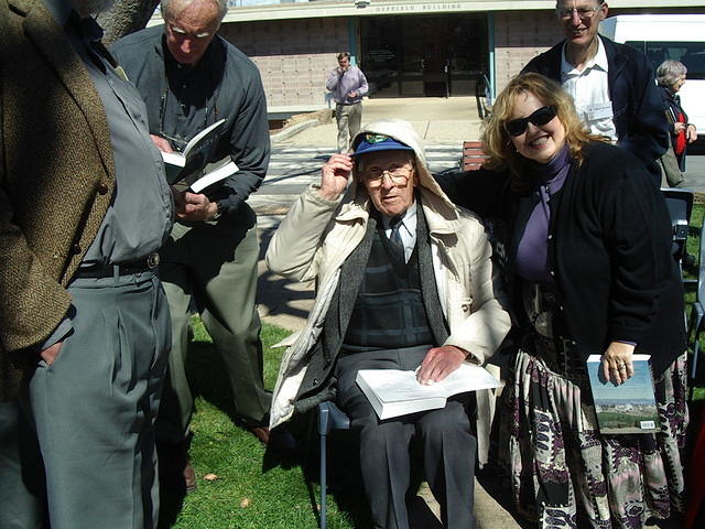 Walter Stibbs signs the page containing his picture for Kim Rawlings