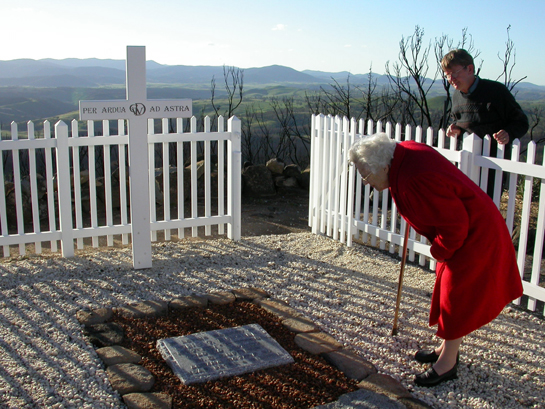 Miss Joan Duffield inspects the repairs to her parents' headstones