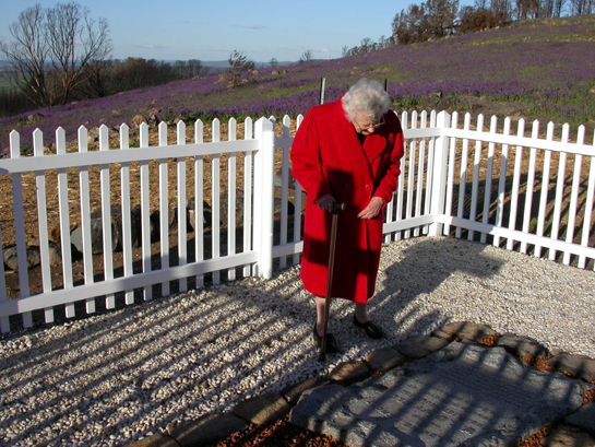Miss Joan Duffield inspects the repairs to her parents' headstones