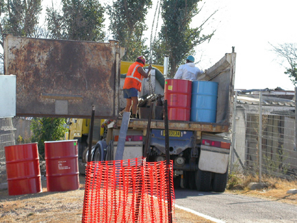 Barrels of contaminated ash from basement.