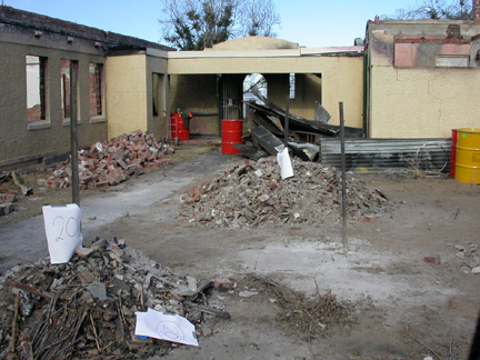 Roofing removed from walkways and outbuildings of main block.