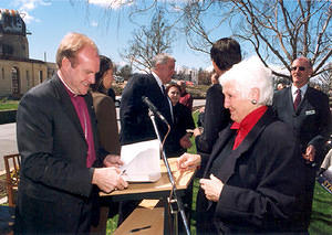 Tom Frame signing the book for Fay Neil