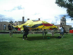 CAS members struggling with tent on a stormy afternoon