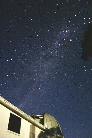 The moonlit ANU 40-inch telescope and building with the Milky Way from Carina to Centaurus rising above it